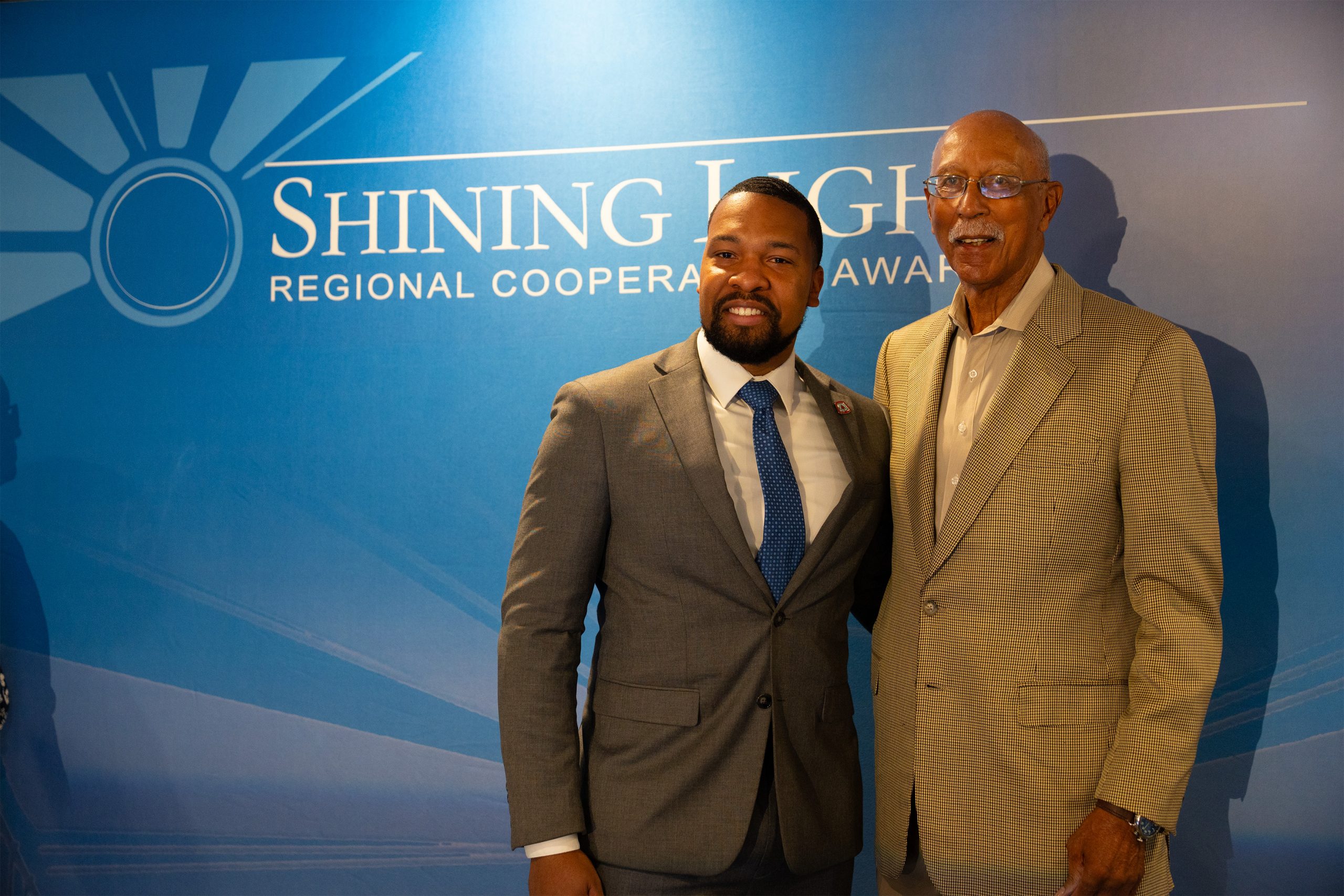 Images from the 2025 SEMCOG Shining Light Awards ceremony, showcasing honorees receiving recognition for outstanding regional cooperation and leadership. The photos feature award recipients posing with plaques, speakers addressing the audience, and attendees gathered in a formal event setting with branded banners and sponsor logos in the background.