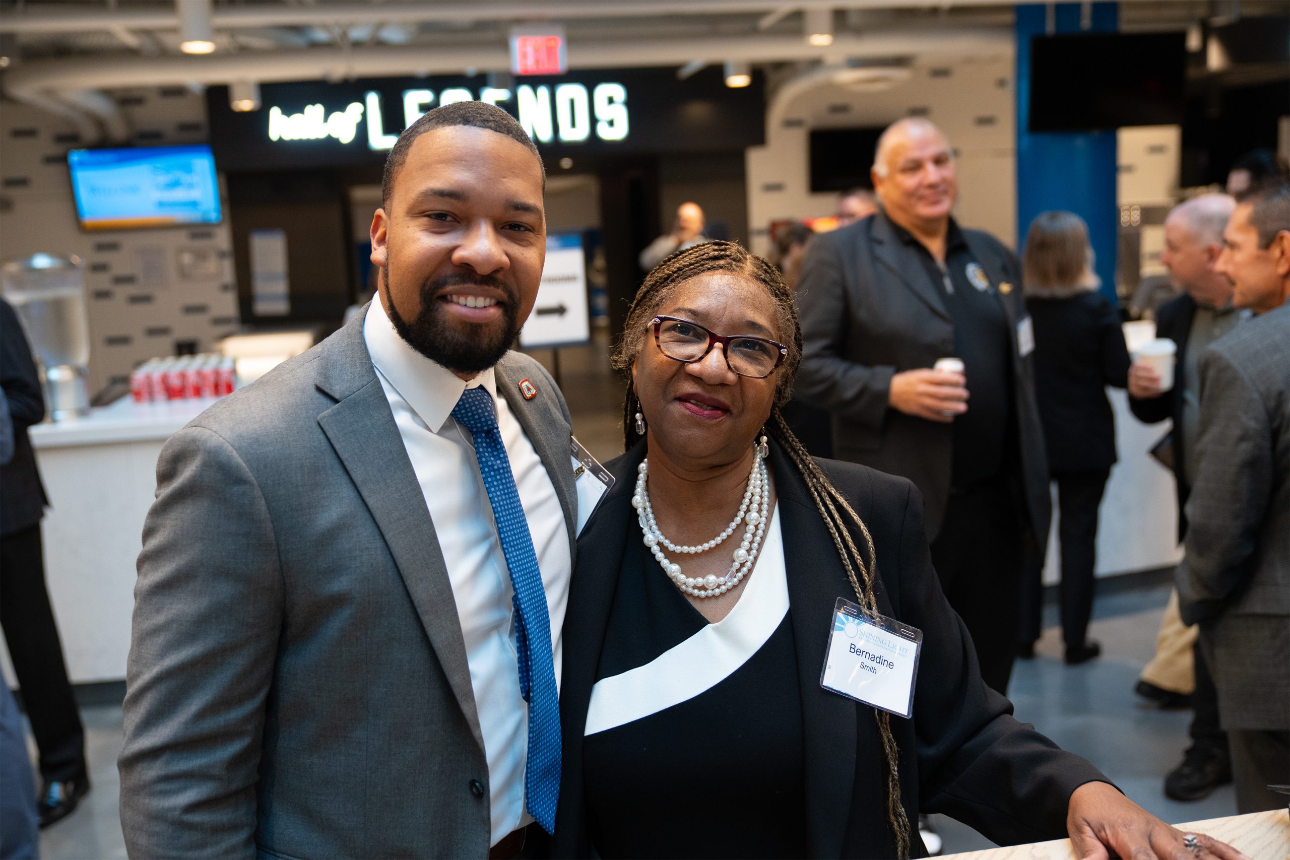 Diverse professional individuals at the Shining Light Awards event celebrating community leaders and achievers, highlighting recognition and empowerment in a corporate networking setting.