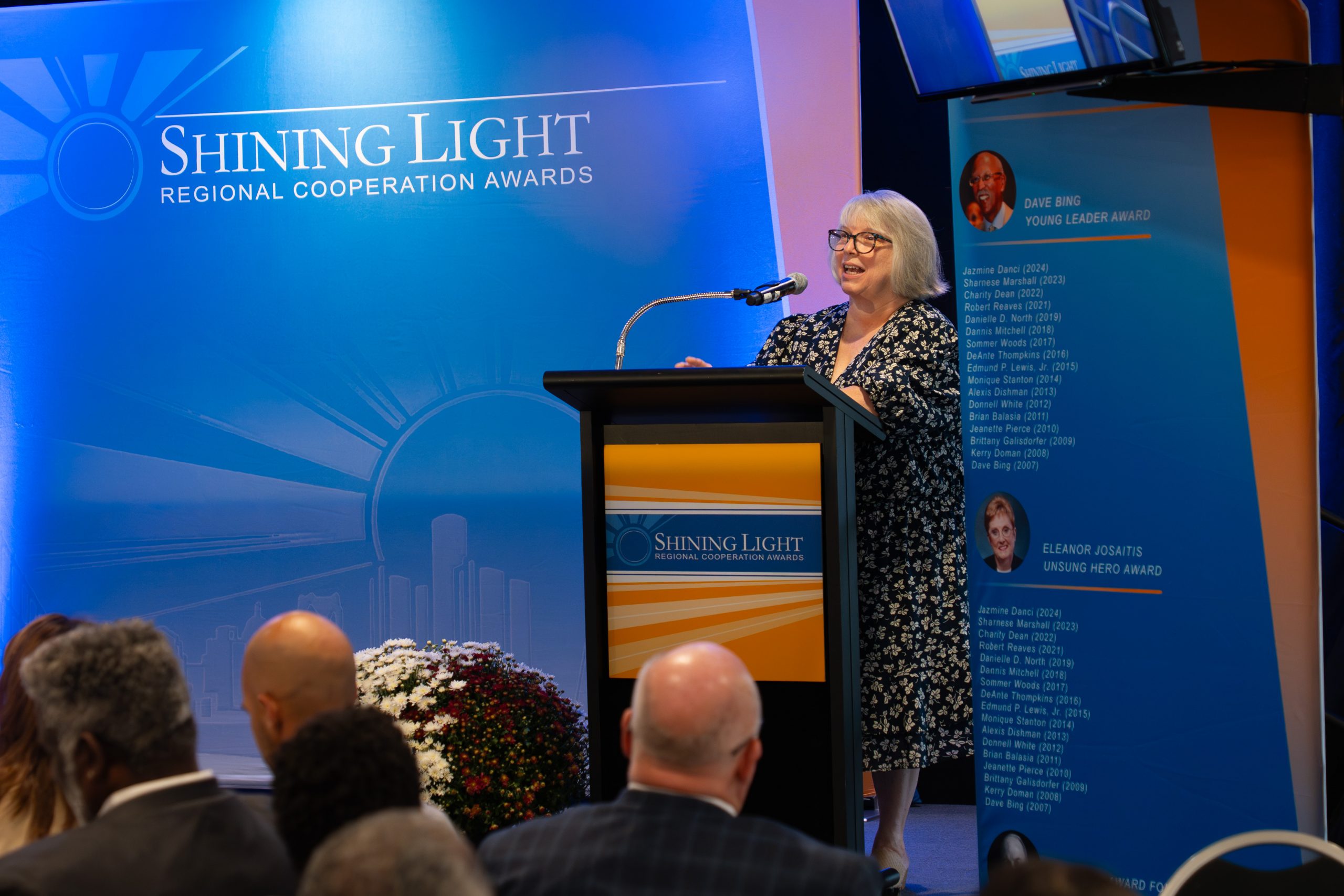 Shining-light-regional-cooperation-awards-2023-ceremony-speaker-woman-at-podium.jpg.