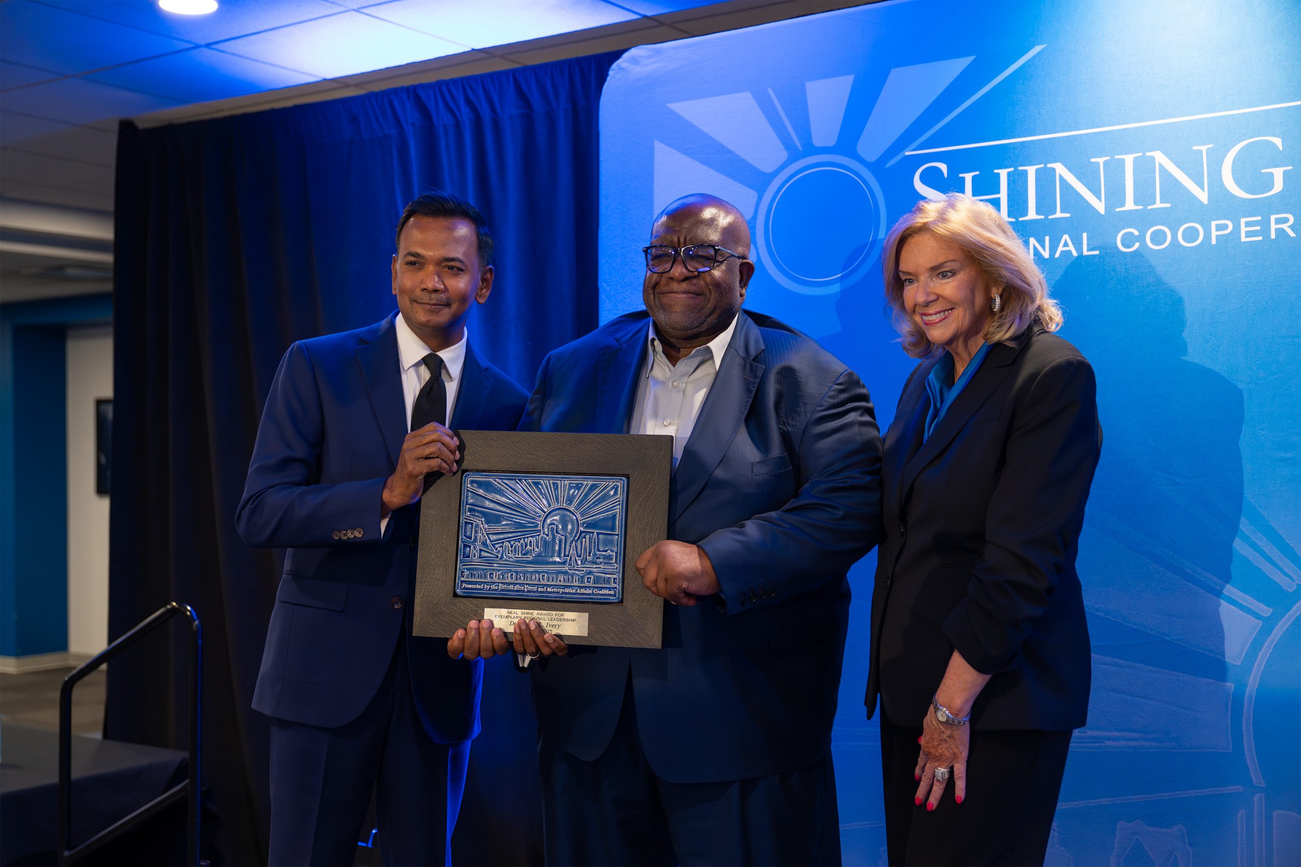 Award ceremony for the Shining Light Award featuring diverse leaders recognizing excellence and inspiring leadership.