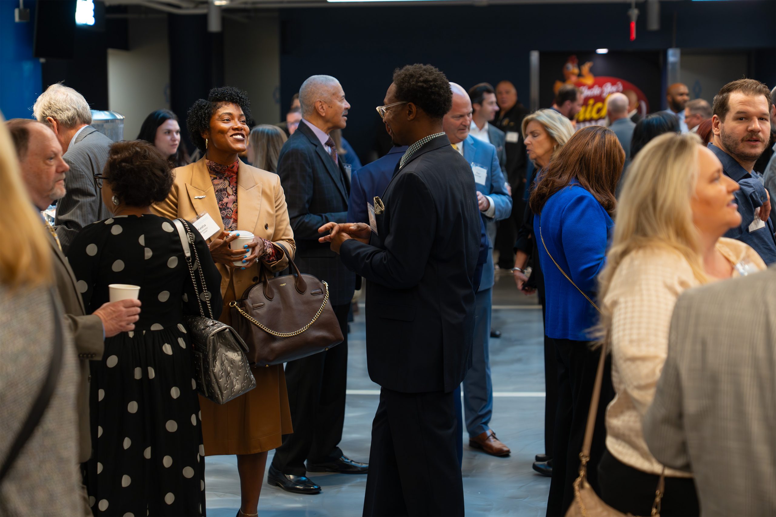 People networking at the Shining Light Awards event, showcasing diversity and professional engagement in a vibrant indoor setting.