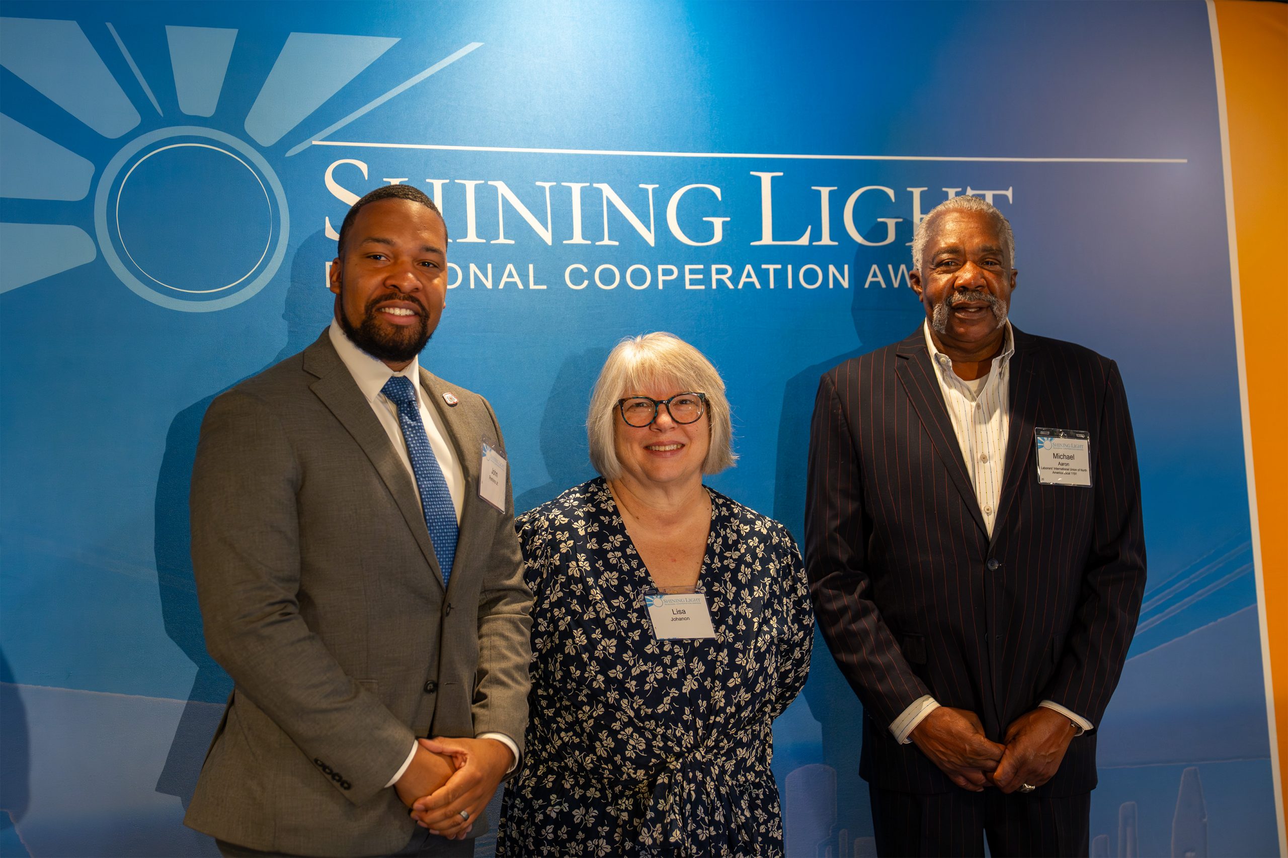Award recipients at the Shining Light Awards in front of the event backdrop, showcasing diversity and recognition for community leaders and organizations committed to positive impact.