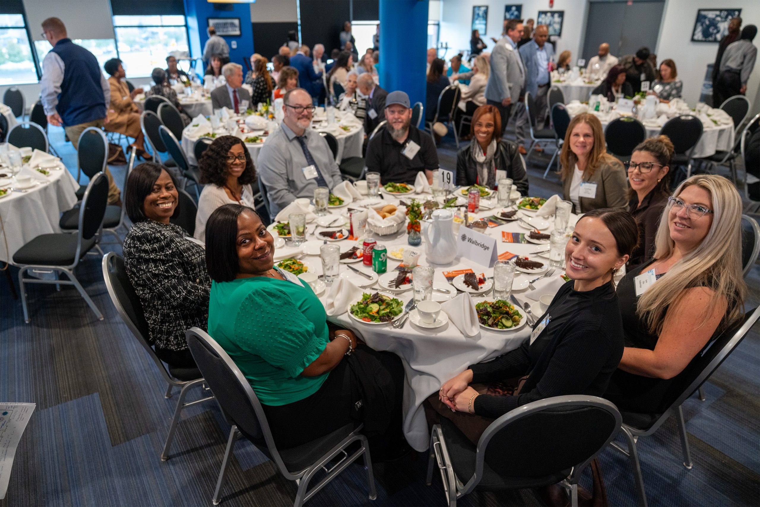 Celebrating leadership and excellence at the Shining Light Awards event with diverse professionals enjoying a formal dinner in an elegant conference setting.